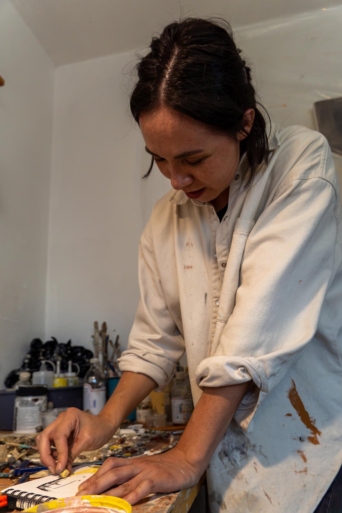 atelier owner arranging embroidered samples